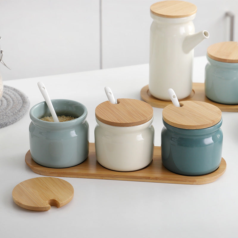 Teal, Light blues and white seasoning organization jars with bamboo like lids and slot for serving spoons