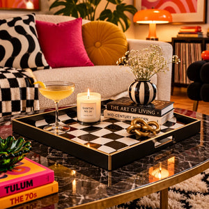 A rectangular serving tray with a black and white wavy checkerboard pattern and a thin gold-toned border, shown on a plain white background.
