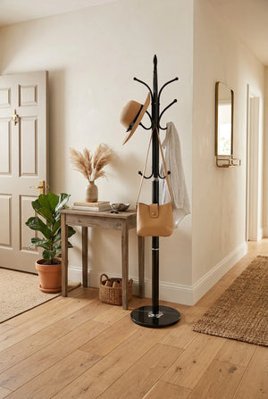 Black coat rack with a hat, bag, and umbrella on a white background