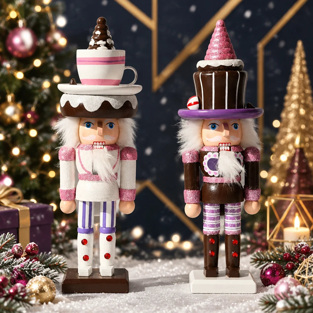Two decorative nutcracker figurines dressed as cupcakes, standing on a white cloud-like surface against a light gray background. The left nutcracker wears a white and pink striped cupcake theme, and the right nutcracker wears a brown and pink cupcake theme.